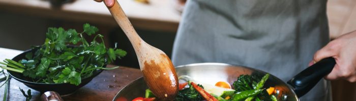 Woman cooking stir fried vegetables