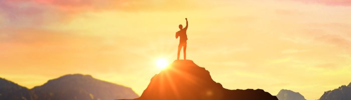 Success Business Leadership, Winner on top. Success. Silhouette man at peak of mountains. Panoramic view on mountains hills Successfully achieving your goal. Successful person has achieving new peak
